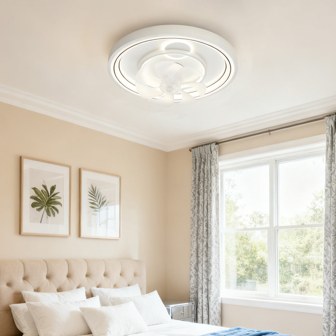 Contemporary ceiling fan with light illuminating bright bedroom with botanical prints and natural light