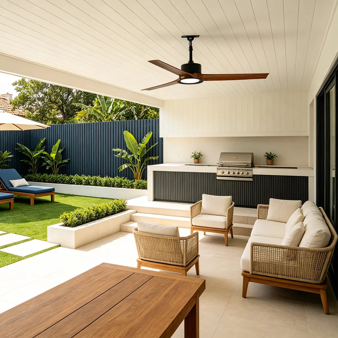 Contemporary ceiling fans with LED lights above a stylish outdoor kitchen and patio lounge.