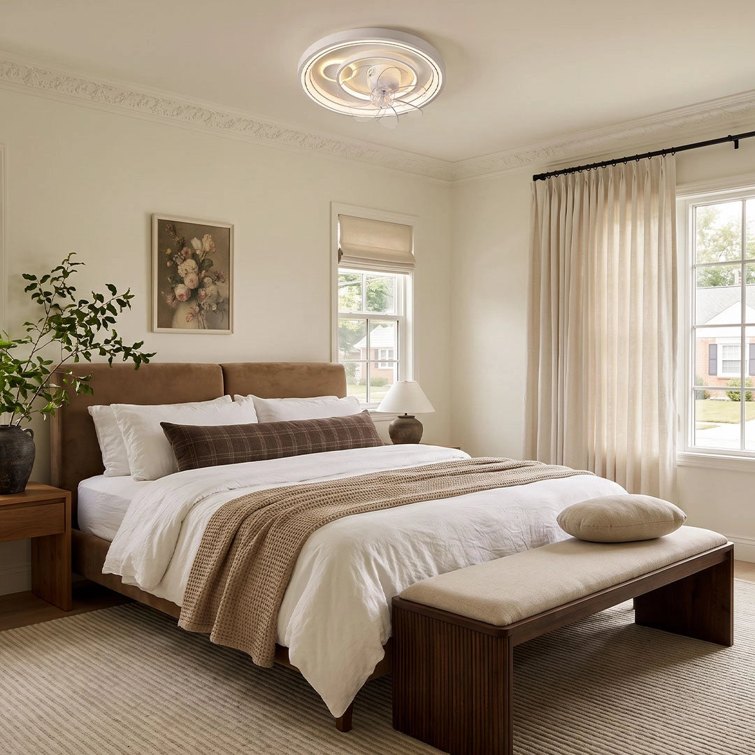 Contemporary ceiling fans with light installed in a bright bedroom with layered neutral bedding and soft natural light.