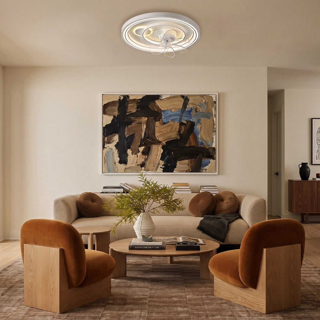 Contemporary ceiling fans with light installed in a cozy living room with sculptural chairs and warm neutral decor.