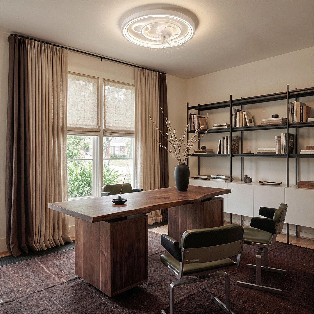 Contemporary ceiling fans with light centered above a stylish home office with a wood desk and open shelving.