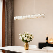 Contemporary chrome chandelier providing elegant focal point lighting above modern dining table