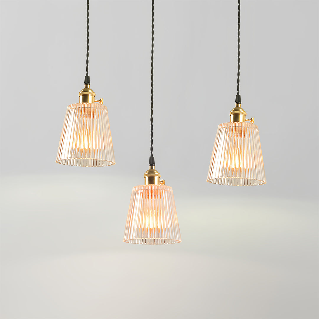 Contemporary clear glass pendant lights creating ambient lighting in modern minimalist dining space