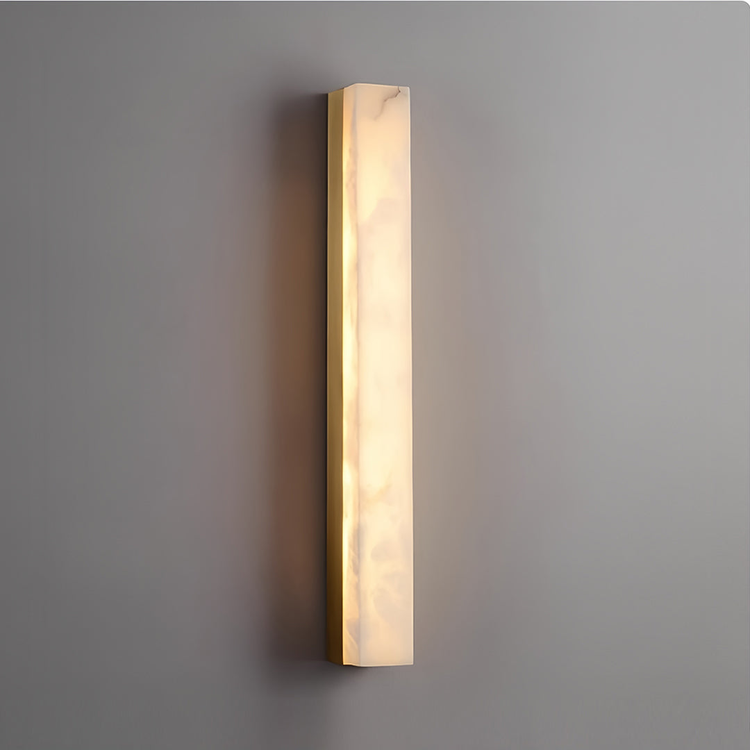 Contemporary copper sconce indoor fixture mounted on dark wall creating dramatic lighting effect
