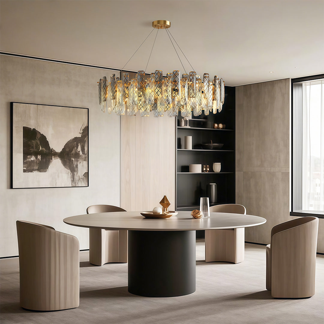 Contemporary crystal chandeliers lighting intimate dining area with brass pedestal table.