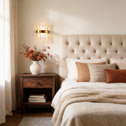 Contemporary crystal wall sconces illuminating a cozy bedroom with warm, elegant glow.