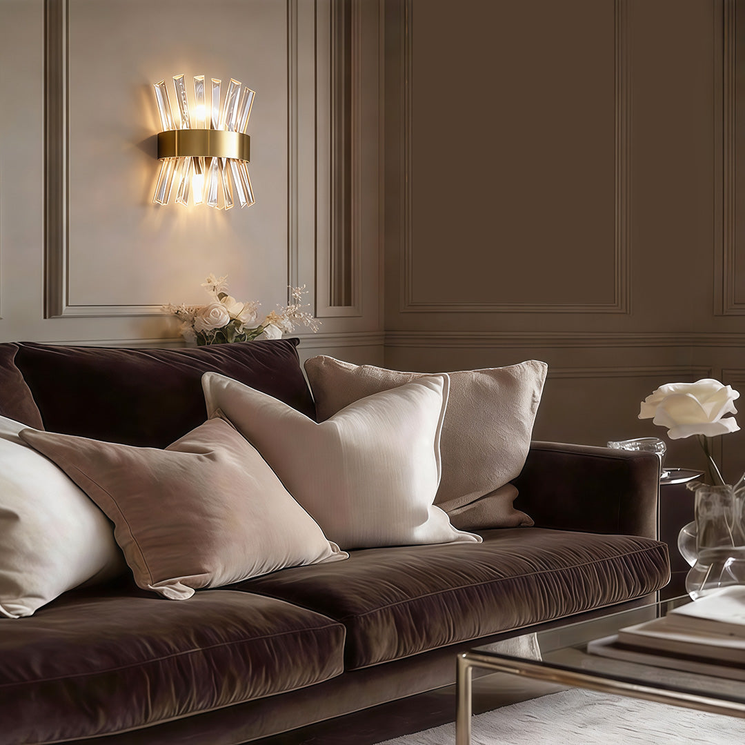 Contemporary crystal wall sconces providing soft light beside a modern sofa setup.