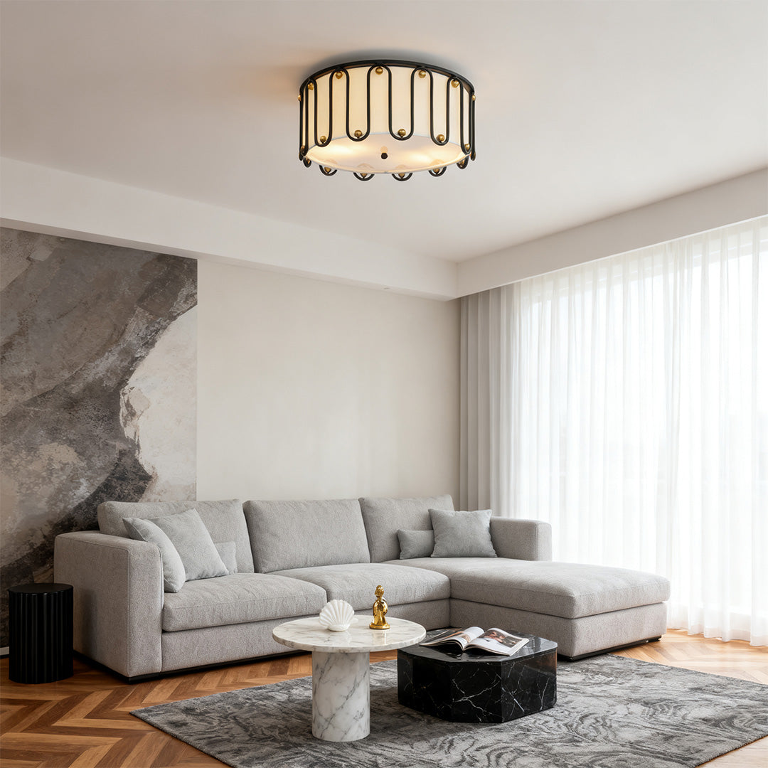 Contemporary living room featuring a decorative drum ceiling light flush mount centered above an L-shaped sectional sofa and marble coffee table.