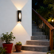 Contemporary decorative wall sconce lighting featuring glass shade chandelier styling creating dramatic up-down illumination on stairway wall.