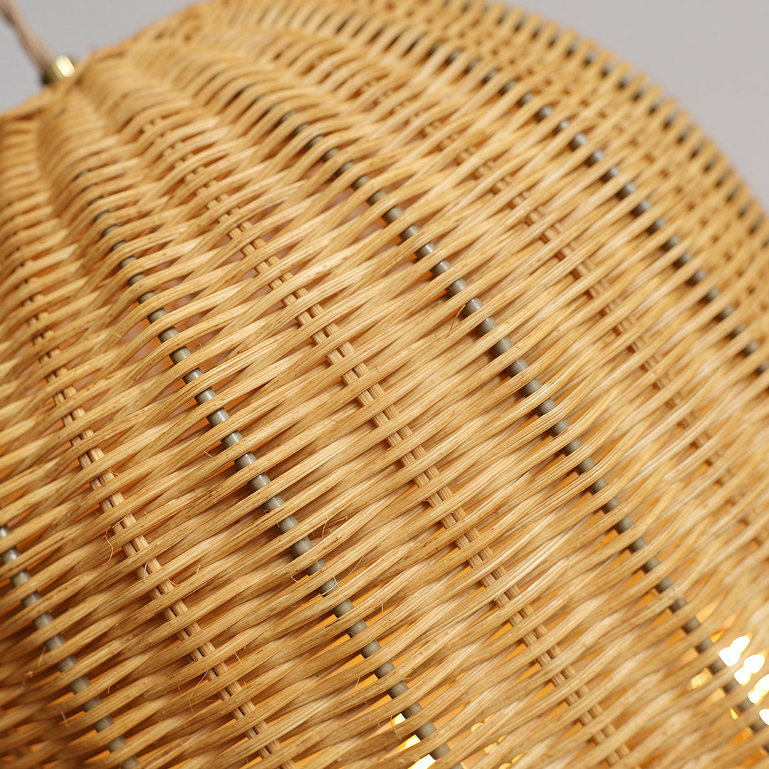Rattan pendant light in a contemporary dining area, adding texture and warmth to the modern decor.