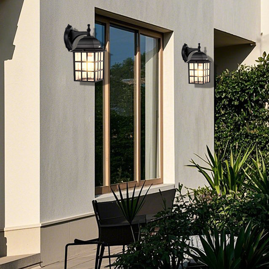 Modern outdoor wall lanterns flanking glass doors on contemporary home exterior with landscaping