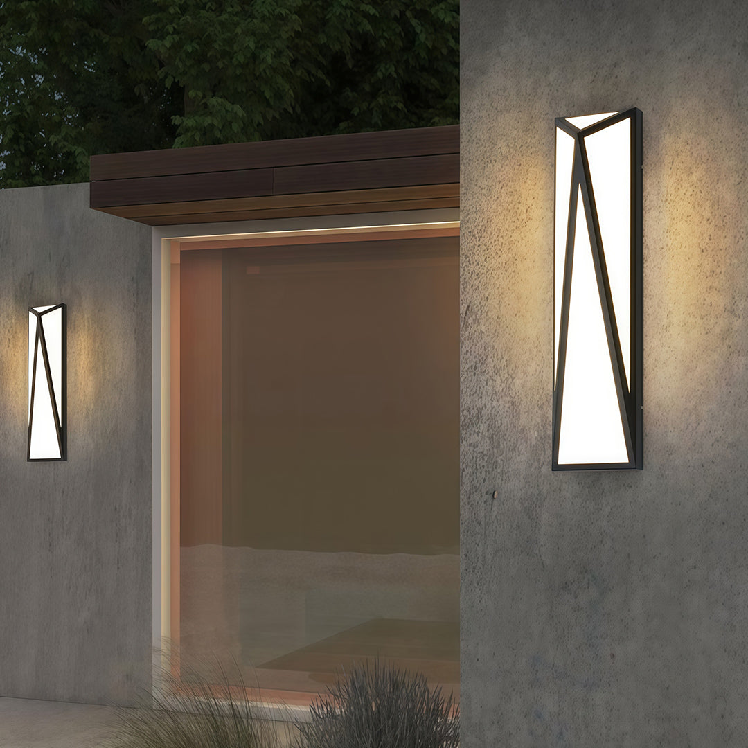 Contemporary exterior wall light black with glass shade chandelier aesthetic providing warm ambient glow in modern covered entryway.
