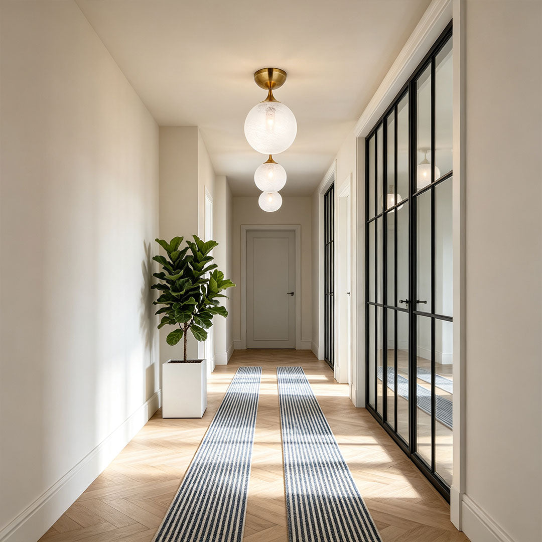 Contemporary flush mount light fixtures arranged in a long corridor with elegant ceiling lighting design.