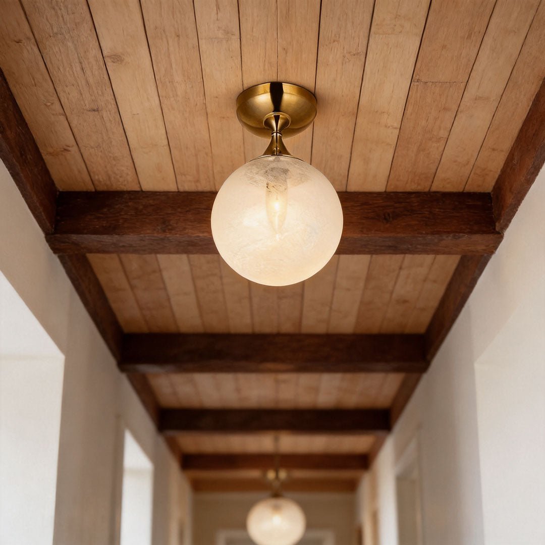 Contemporary flush mount light fixtures installed along a rustic hallway ceiling with warm ambient lighting.