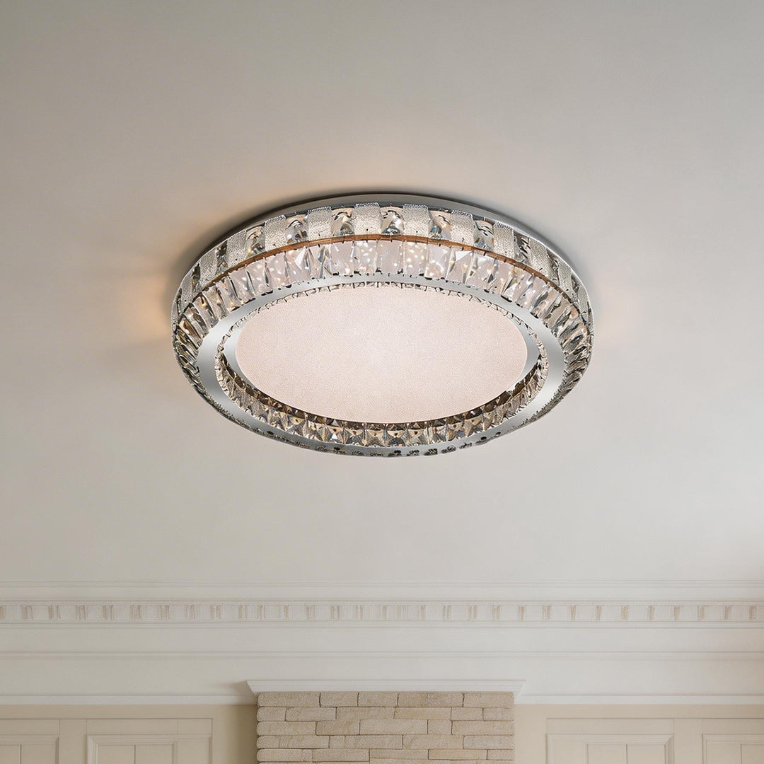 Elegant contemporary flush mount light with a silver crystal ring and textured frosted center.