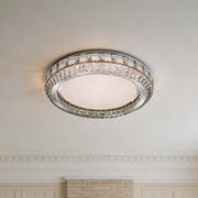 Elegant contemporary flush mount light with a silver crystal ring and textured frosted center.