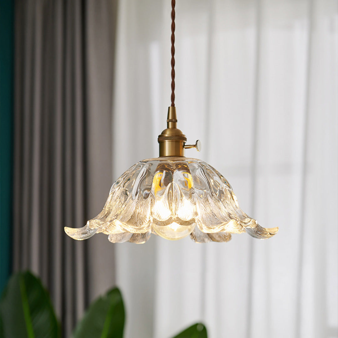 Contemporary flower pendant lighting with fluted glass shade in modern minimalist interior setting.