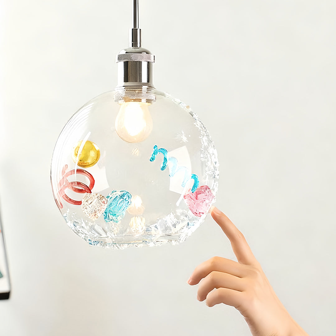 Contemporary globe coloured glass pendant lights with vibrant crystals and artistic metallic pieces inside.