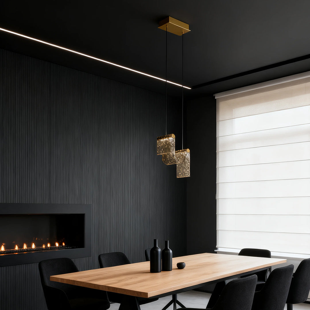 Contemporary gold pendant island light brightening modern conference room with wood table and black chairs