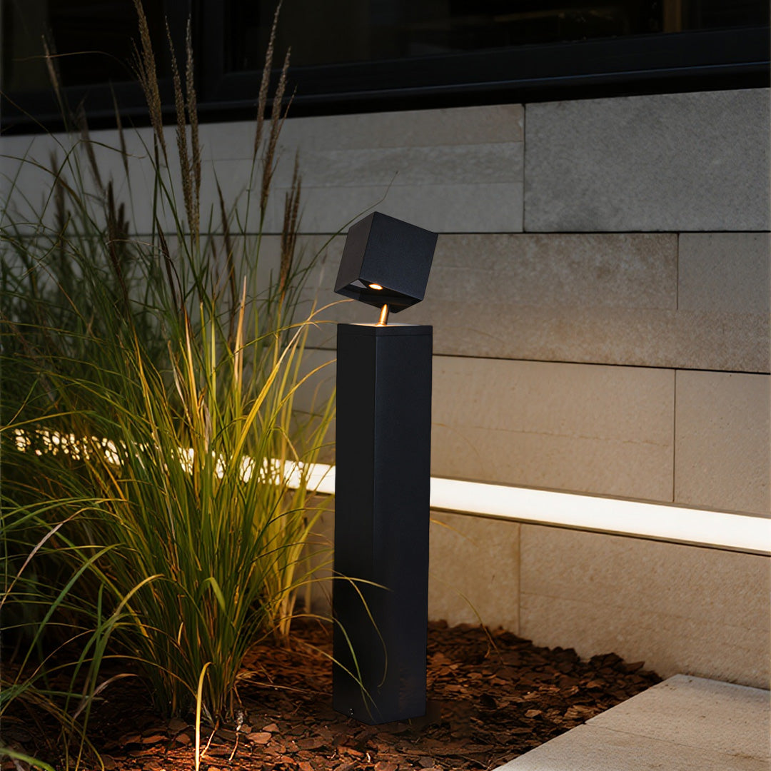 Pathway outdoor light enhancing contemporary landscape design with ornamental grasses and clean hardscape elements