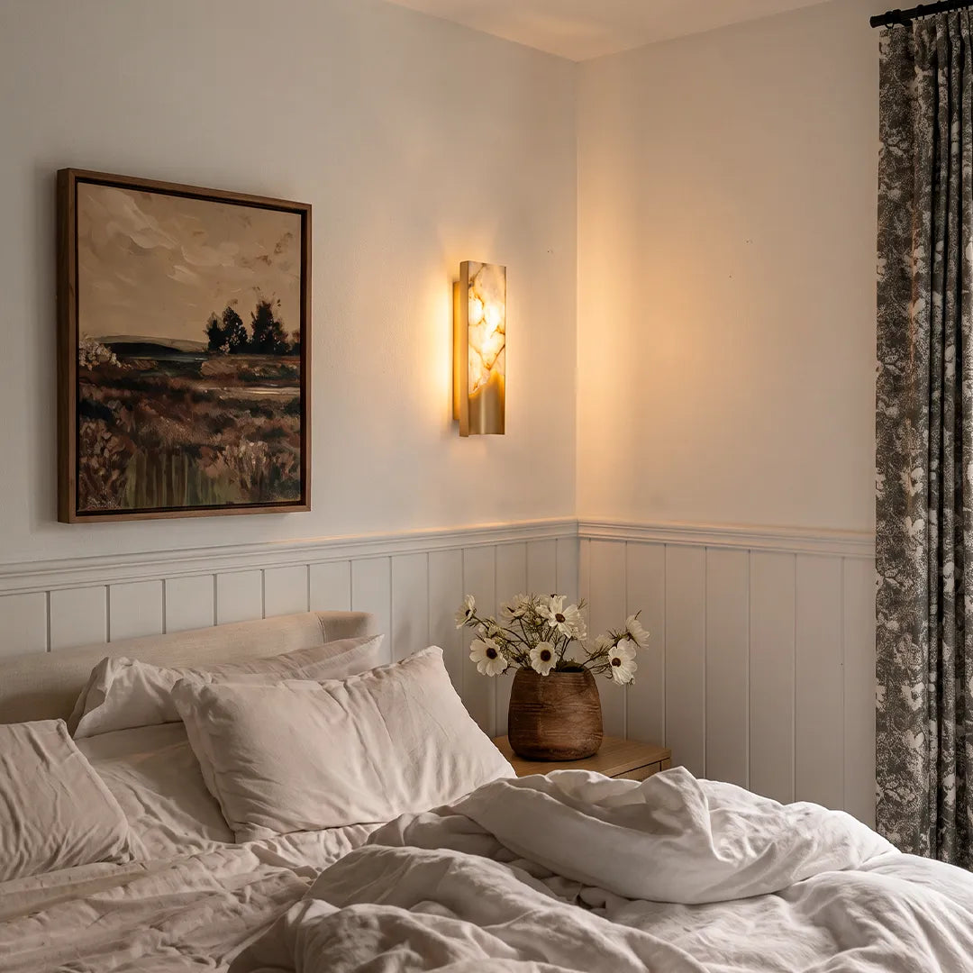 Contemporary indoor wall lights installed above a bed in a soft neutral bedroom.