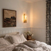 Contemporary indoor wall lights installed above a bed in a soft neutral bedroom.