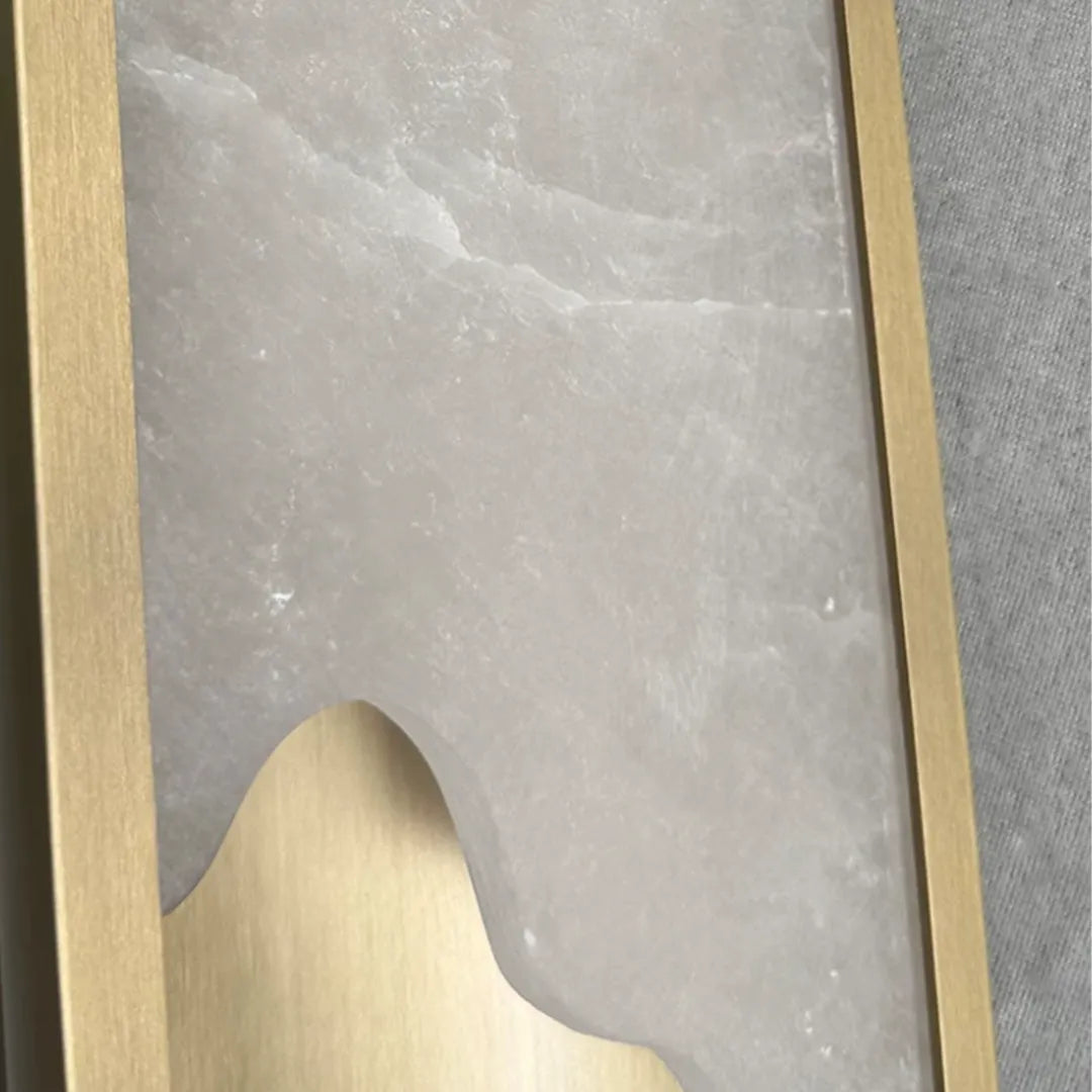 Contemporary indoor wall lights detail showing a translucent stone-inspired panel with brass trim.