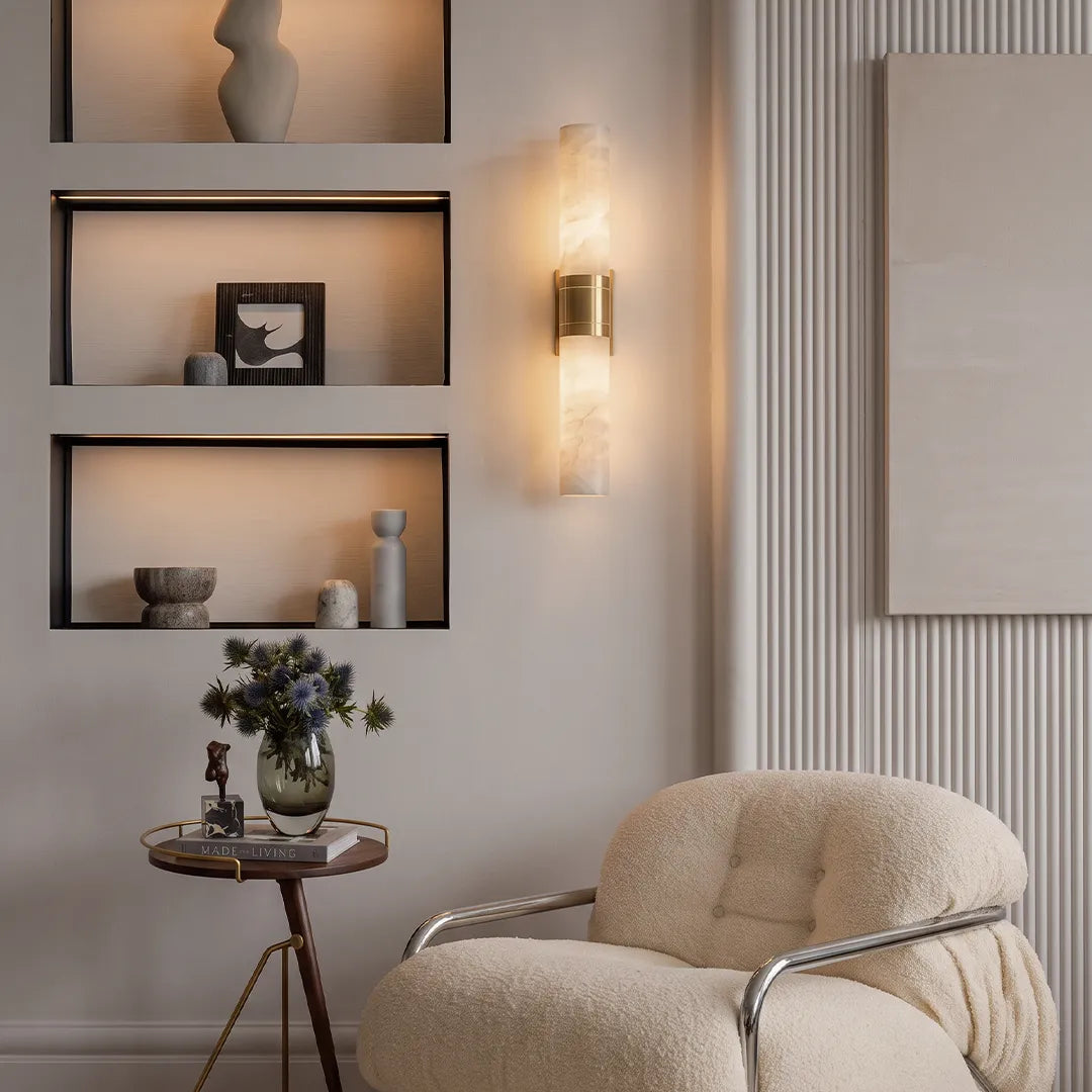 Contemporary indoor wall sconces accenting a modern living room wall with a slim vertical form and soft warm glow.