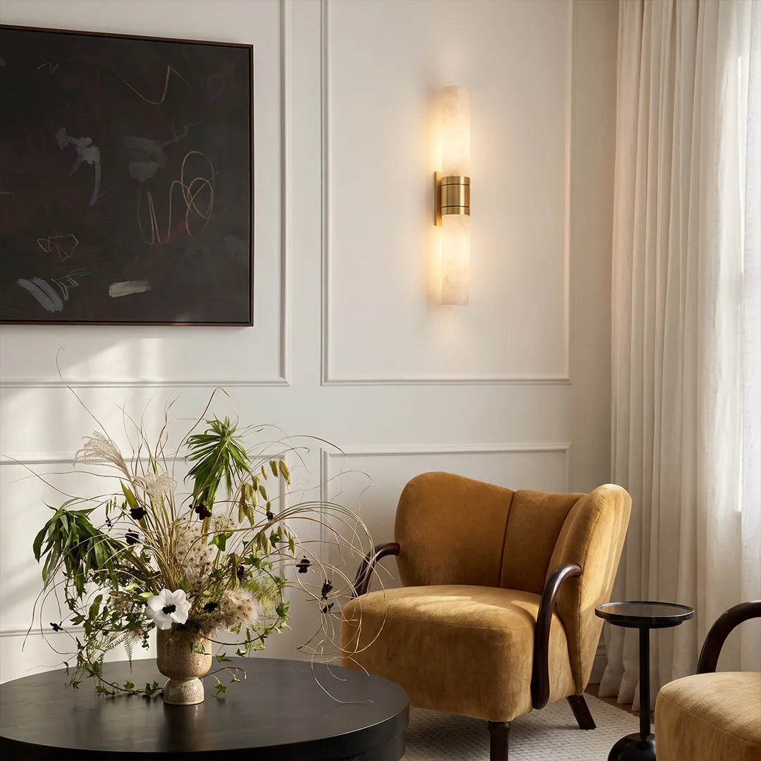 Contemporary indoor wall sconces illuminating a modern sitting area with a vertical stone-look design and soft warm light.