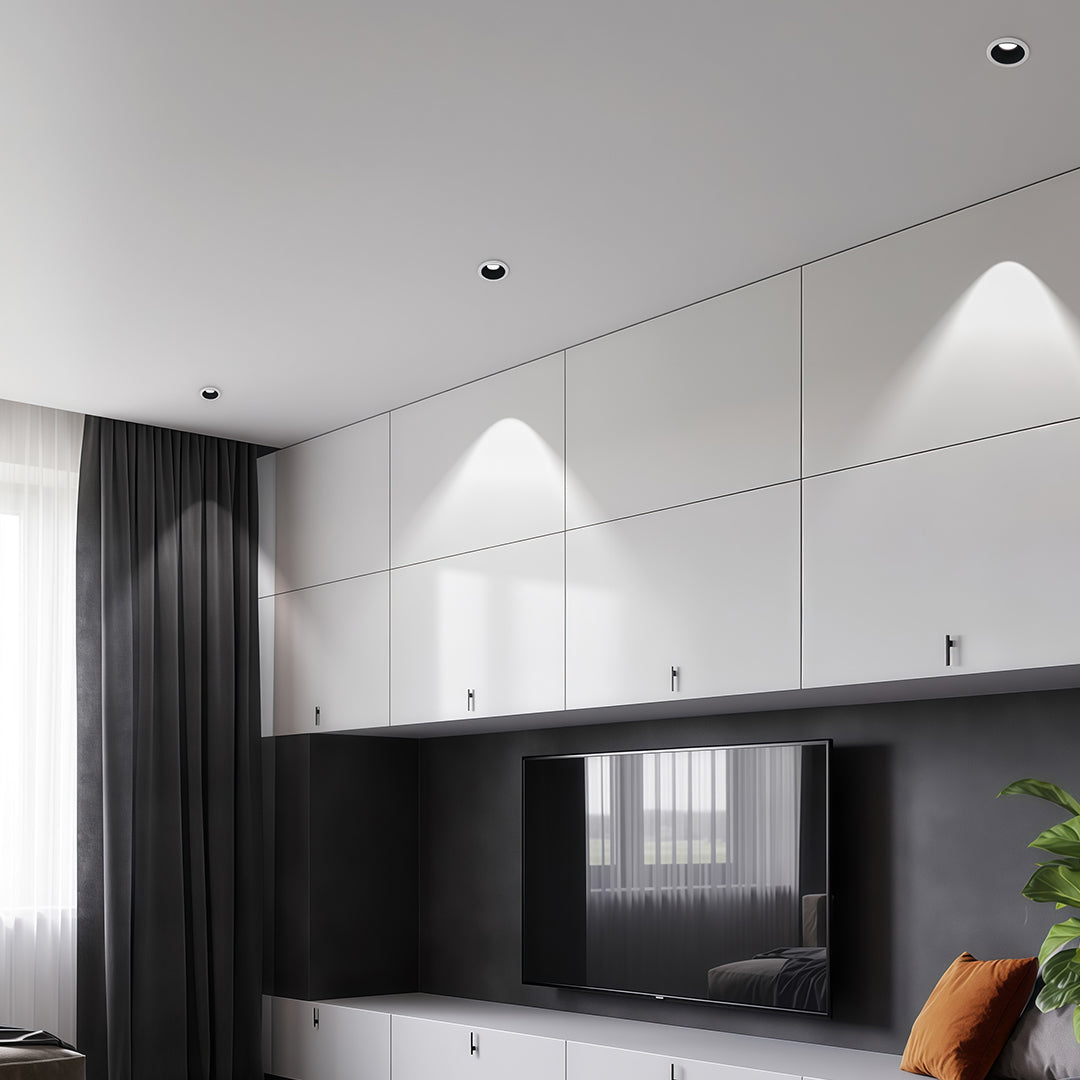 Contemporary interior spotlights with glass shade chandelier styling illuminating modern black and white living space.