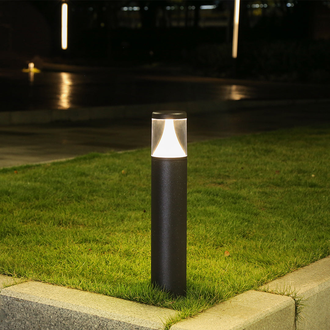 Tall black cylindrical post light with minimalist design and directional downward illumination