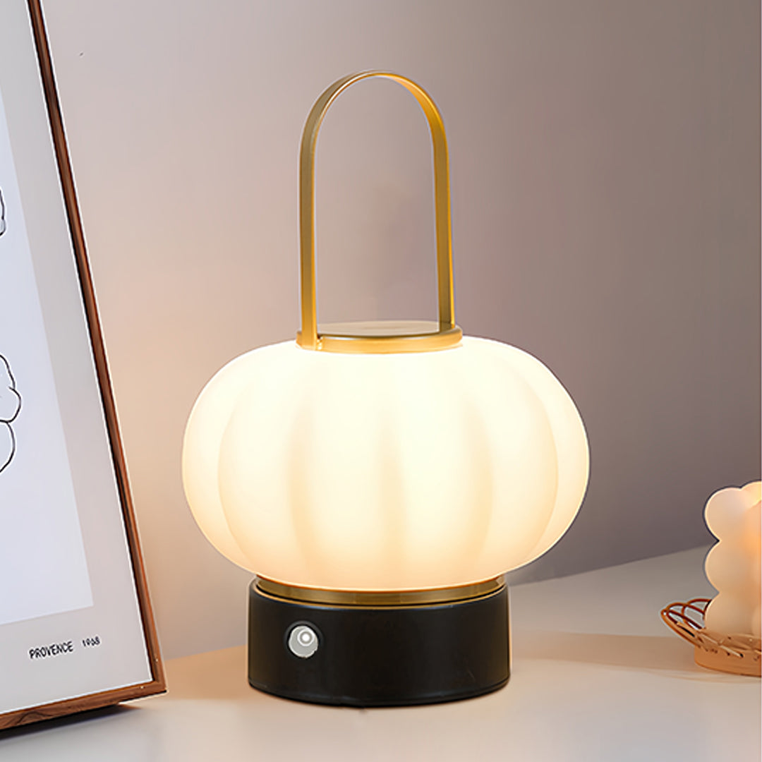 Contemporary lantern table lamp with brass handle creating atmospheric lighting on side table