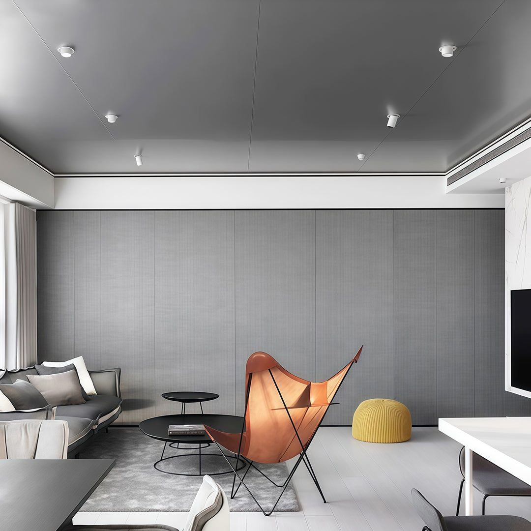 Contemporary LED indoor spotlights with glass shade chandelier styling illuminating modern living space with gray accent wall.