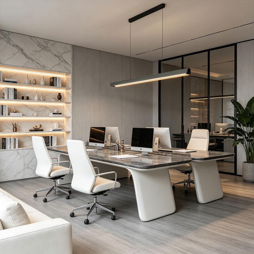 Contemporary LED linear suspension light illuminating a stylish modern workspace.