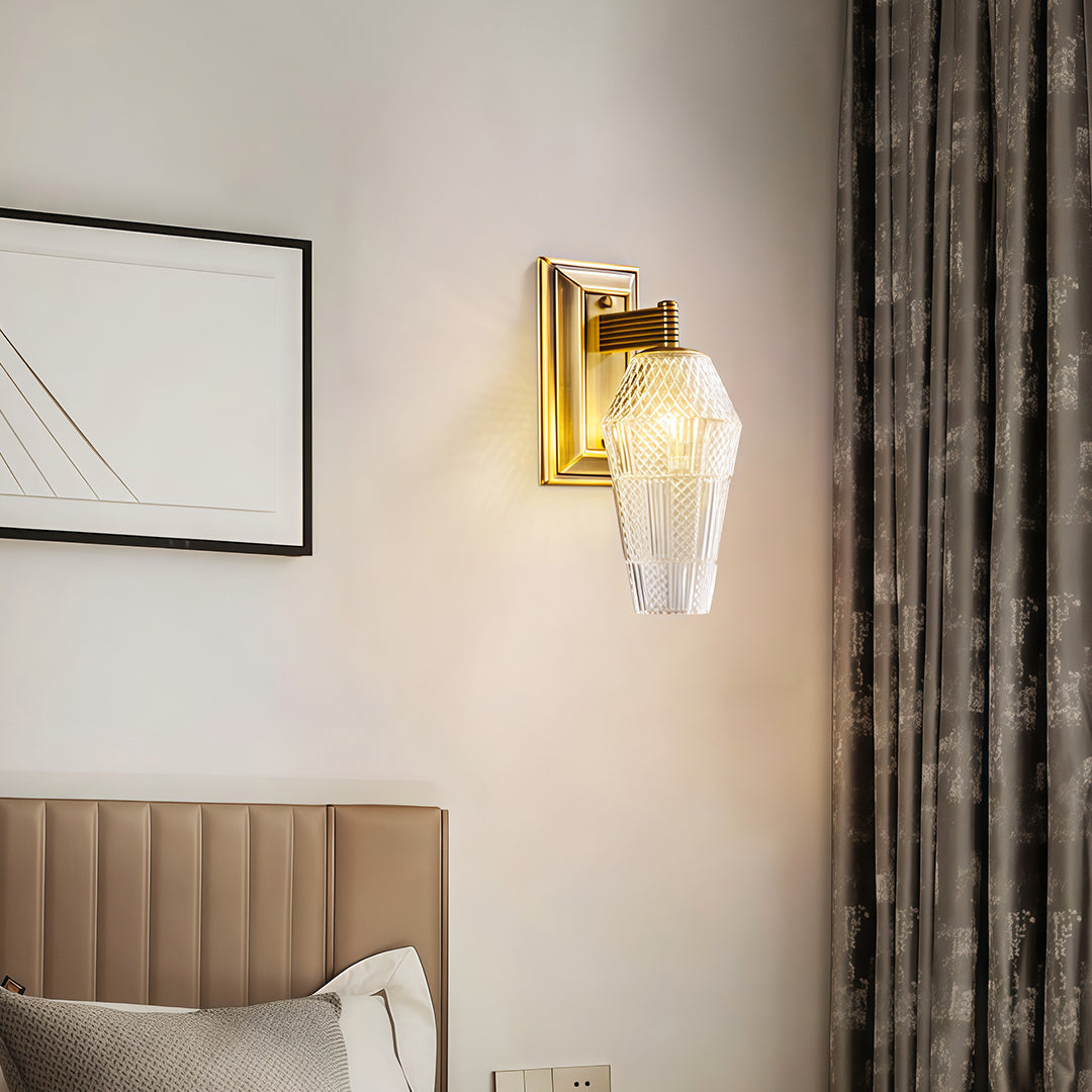 Contemporary LED wall sconce lights featuring glass shade chandelier styling illuminating bedroom above upholstered headboard.