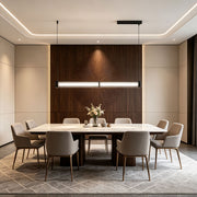 Contemporary linear suspension lighting installed above a modern dining conference room with elegant interior styling.