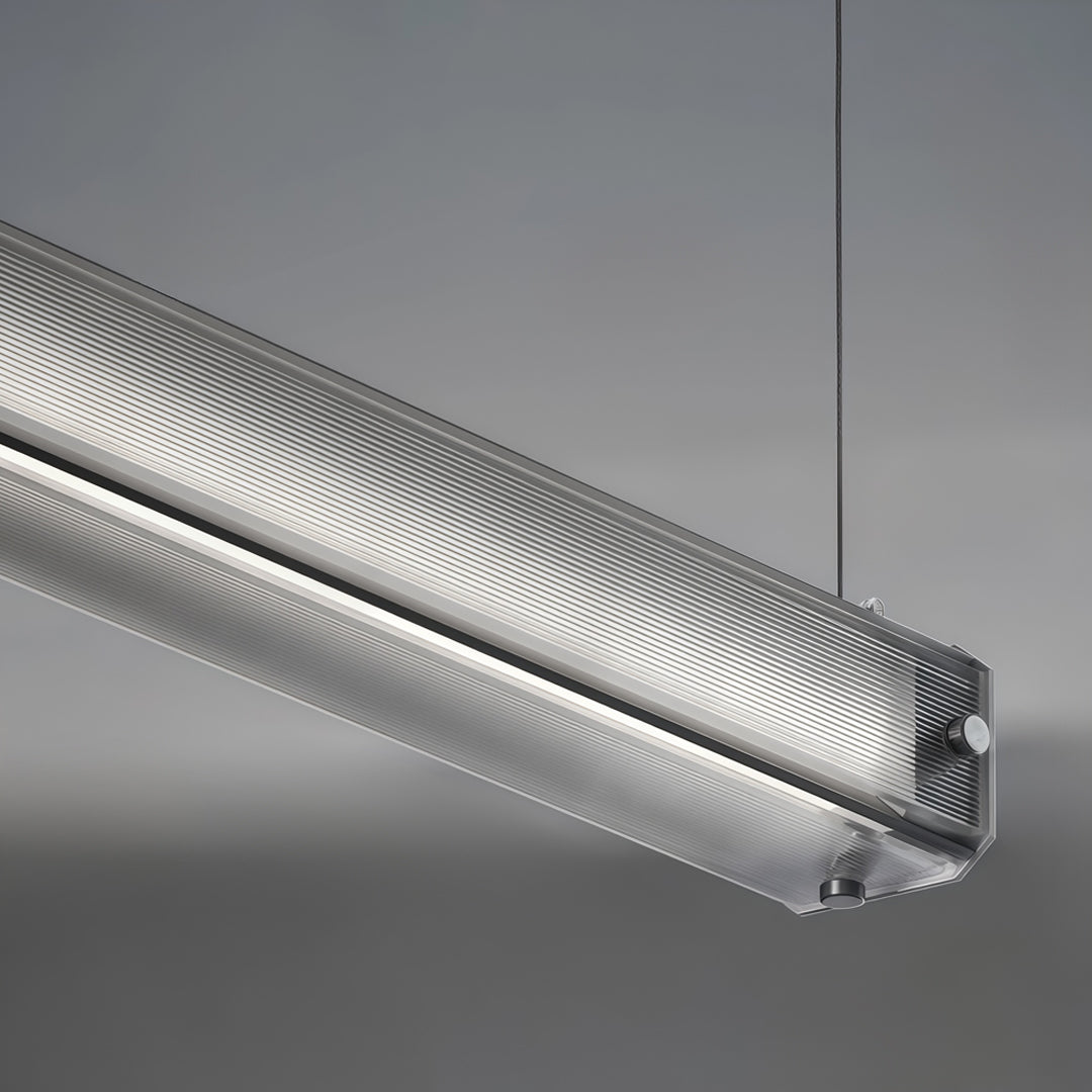 Close-up detail of contemporary linear suspension lighting featuring textured aluminum housing and LED diffuser.