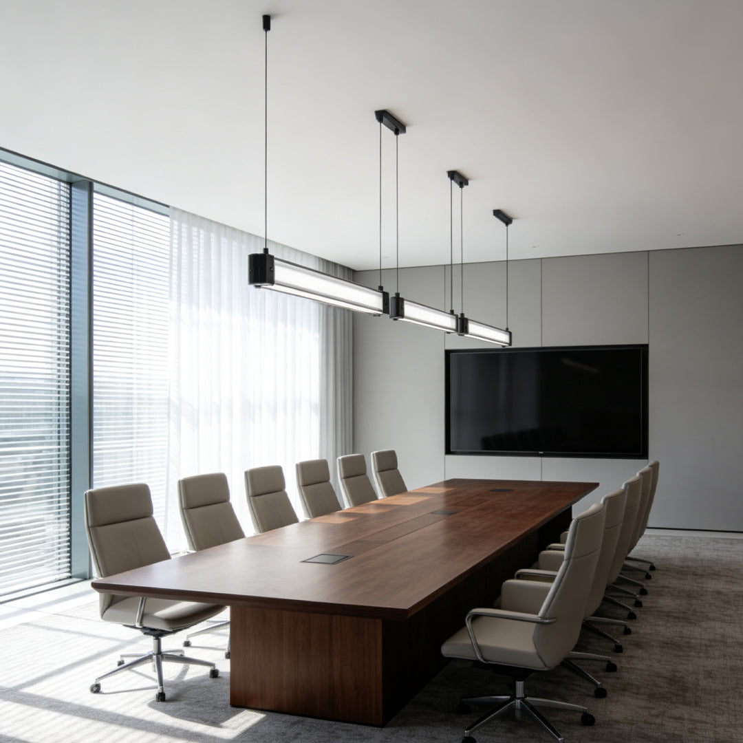 Modern contemporary linear suspension lighting featured over a luxury meeting table in a corporate office.