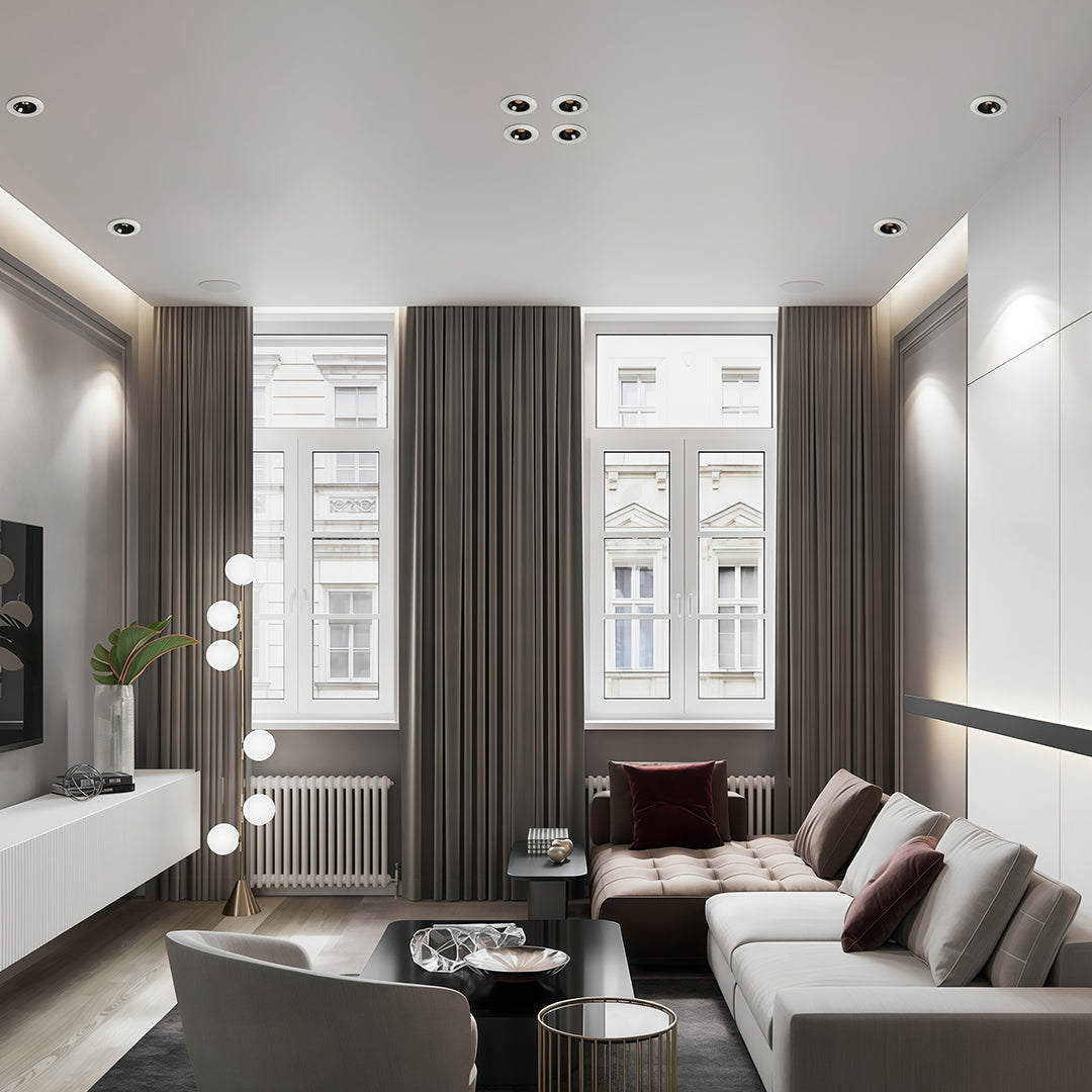 Contemporary living room using adjustable directional recessed downlight fixtures to provide accent lighting.