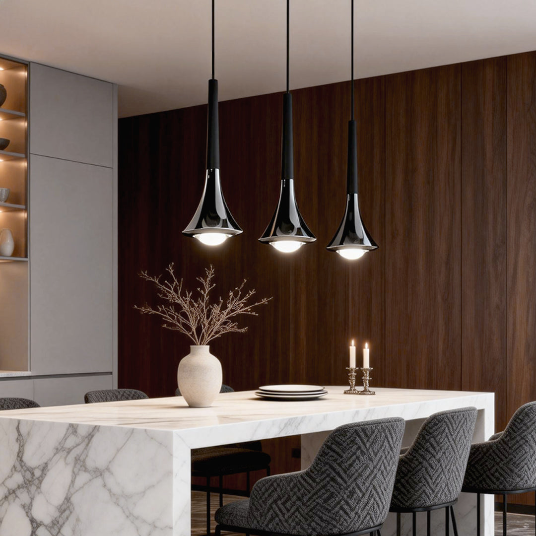 Contemporary mini pendant lights installed over a marble kitchen island, blending sleek metal finishes with warm light.