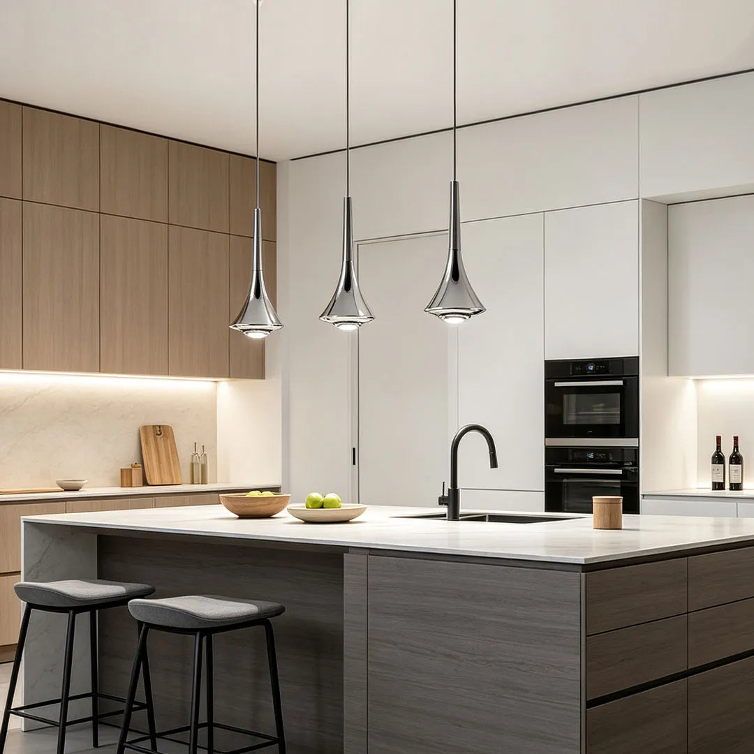 Contemporary mini pendant lights installed above a minimalist kitchen island with light wood cabinetry and bar seating.