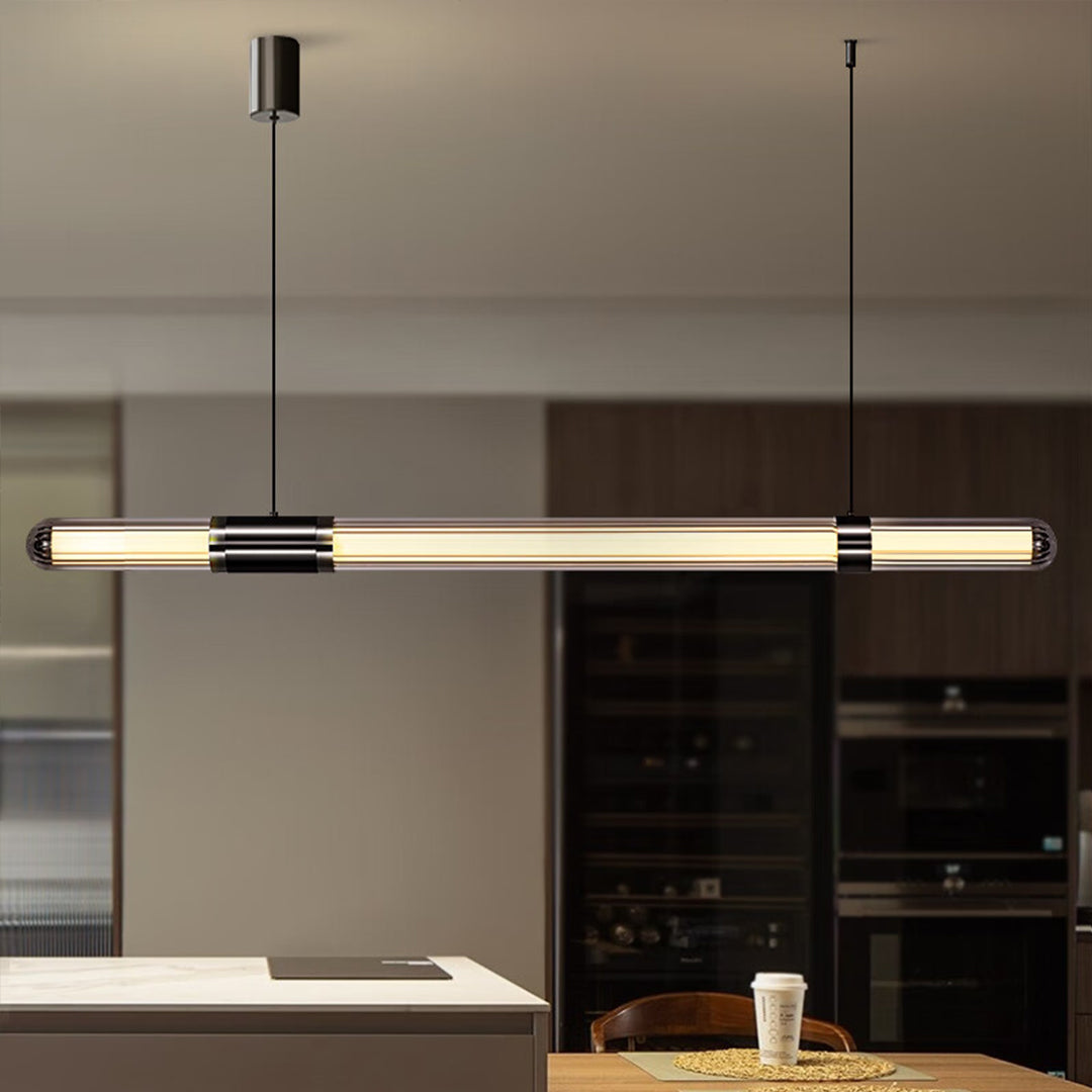 Contemporary modern linear suspension lighting with slim bar design in a clean modern kitchen.