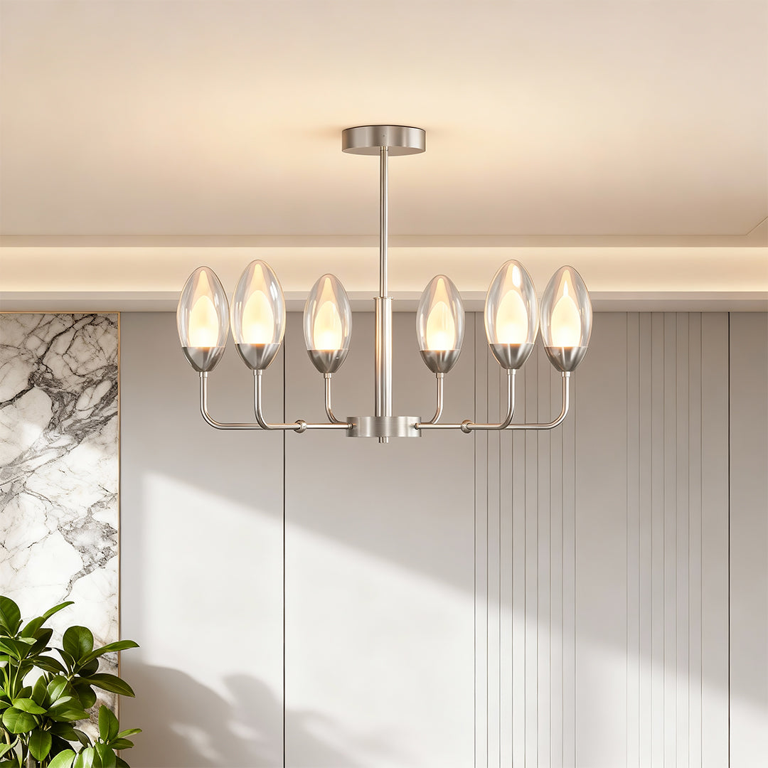 Contemporary modern minimalist chandelier with glass shade chandelier design illuminating bright white dining room with natural light.