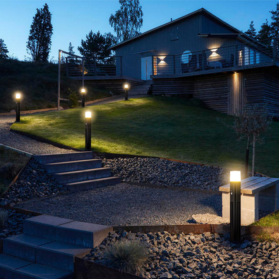 Contemporary outdoor lighting illuminating residential landscape and garden pathways at twilight
