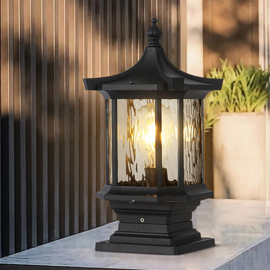 Contemporary outdoor lantern with warm LED lighting positioned on modern wooden deck