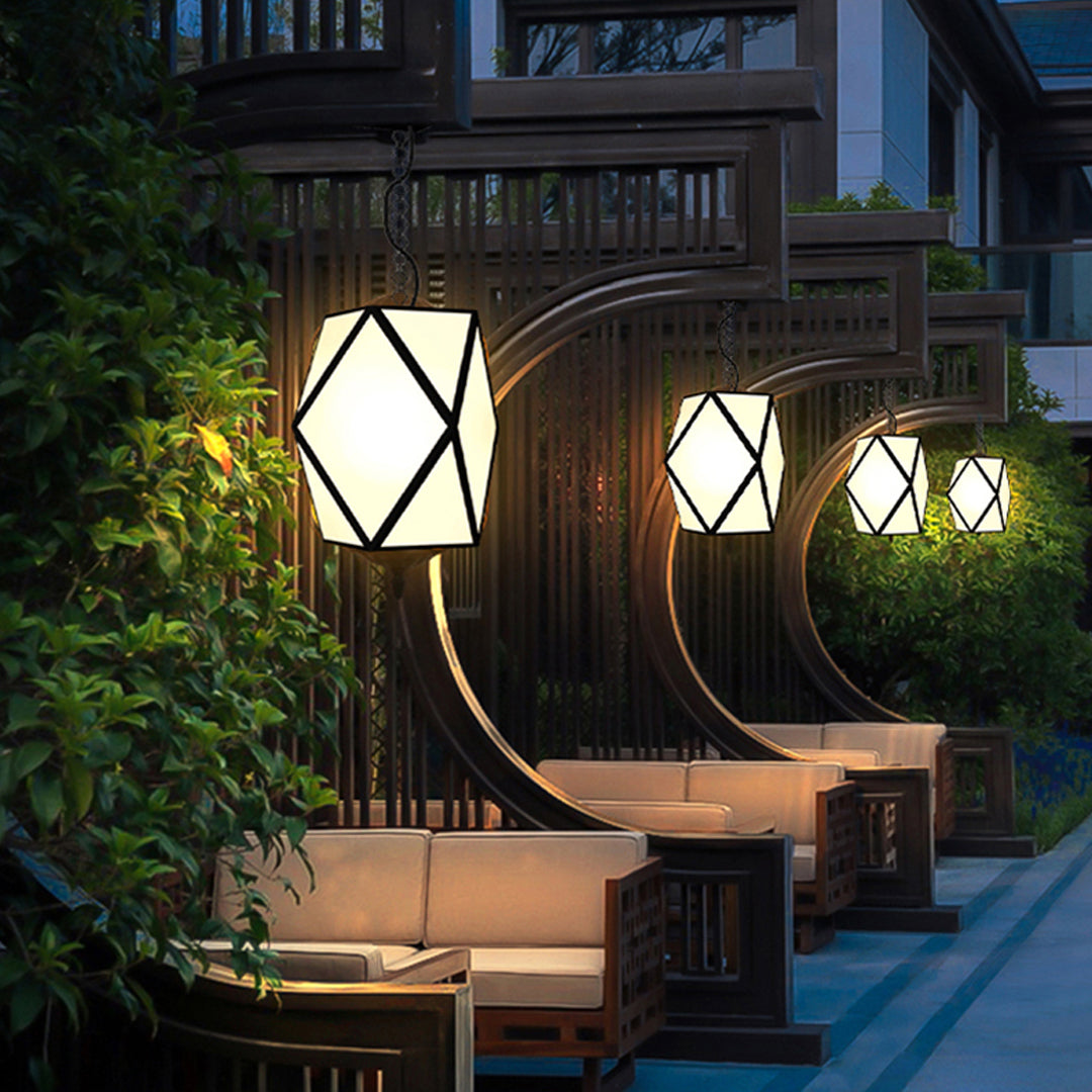 Cozy patio area illuminated by contemporary outdoor pendant lighting with geometric hanging lantern design.
