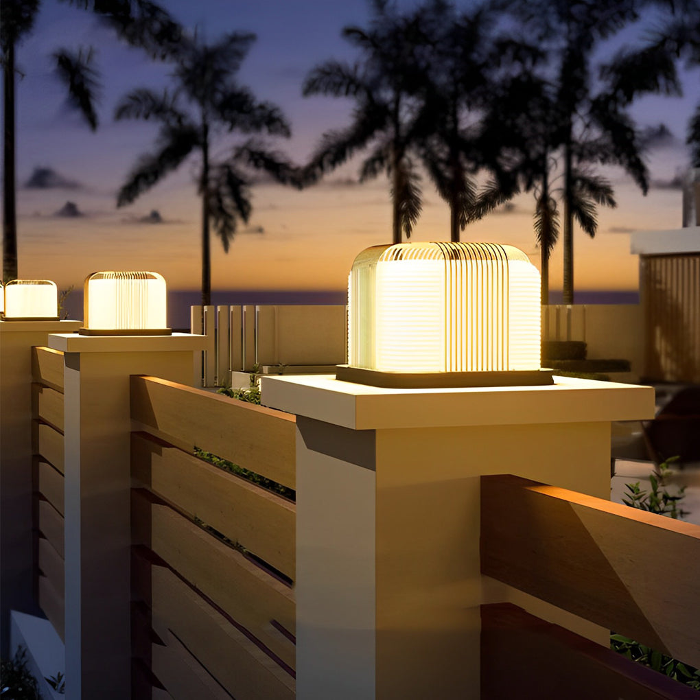 Contemporary outdoor pillar lights with a close-up of their illuminated curved structure.