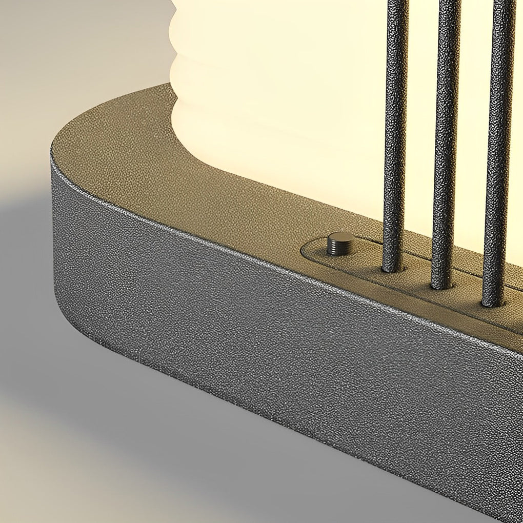 Contemporary outdoor pillar lights with a sleek design, illuminating a backyard setting.