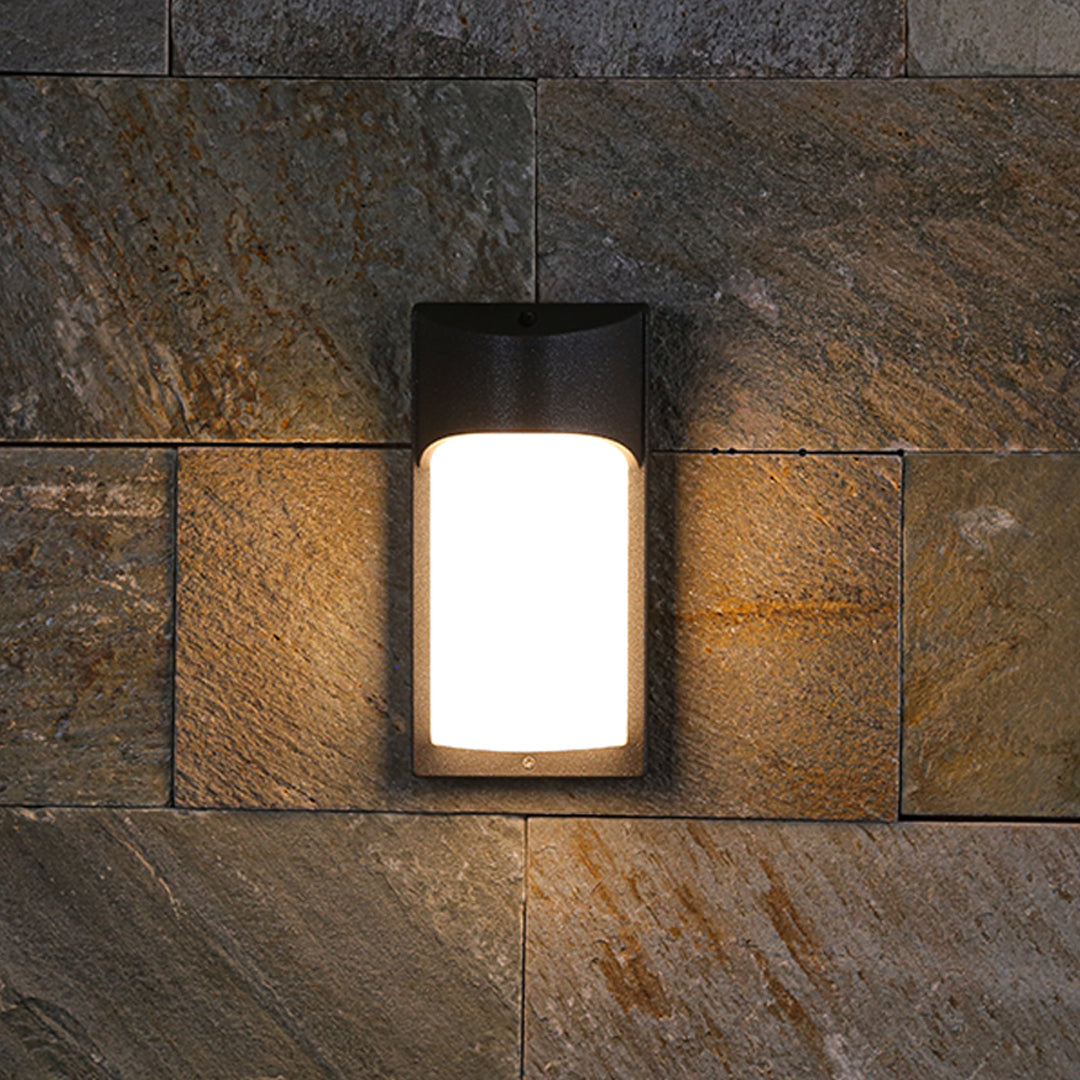 Contemporary outdoor wall sconces mounted on dark wood siding providing architectural accent lighting