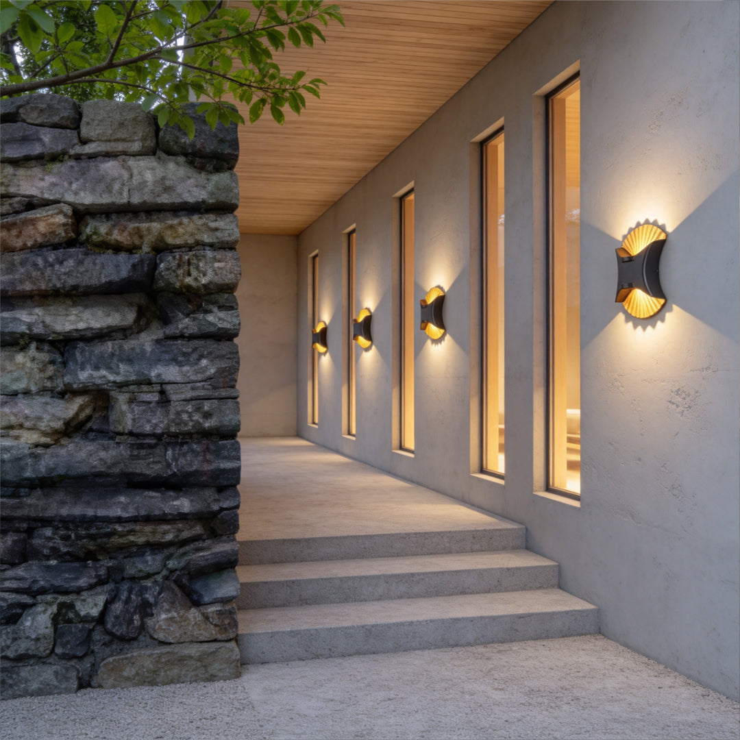 Contemporary outdoor up down wall light mounted along textured stone corridor with warm glow.